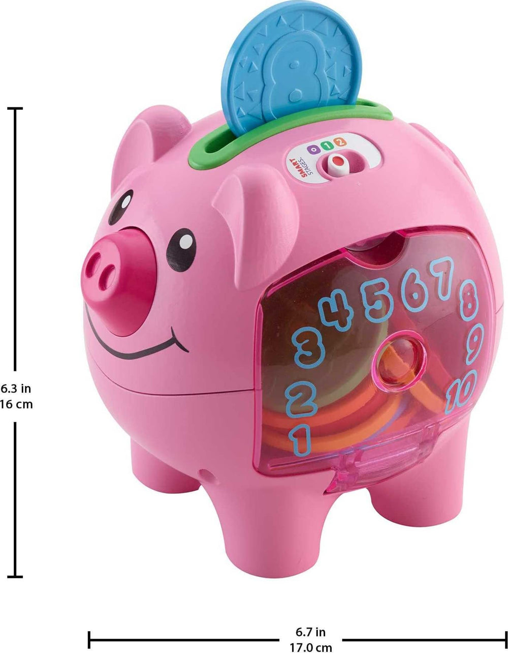 Fisher-Price piggy bank beside a hand for scale showing compact, toddler-friendly size