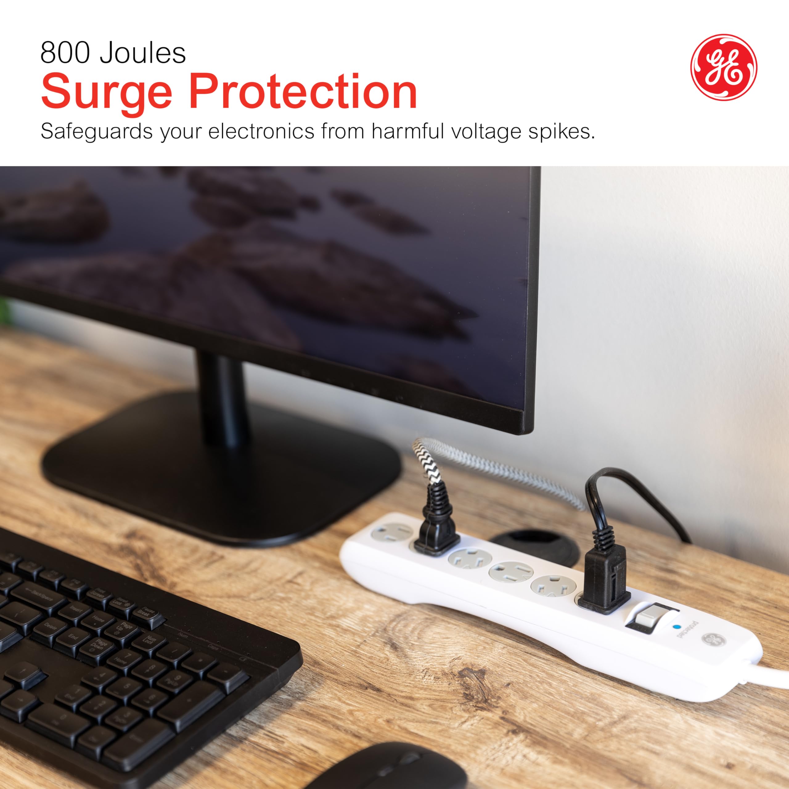 GE surge protector on desk powering devices for organized, protected setup