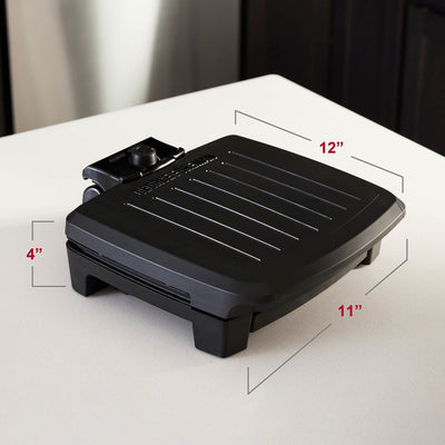 George Foreman grilling burgers and vegetables to show even cooking and family servings