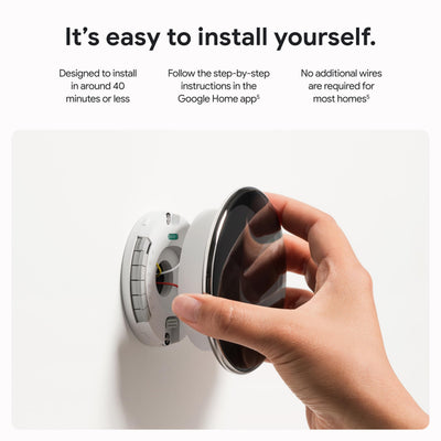 Google Nest thermostat held in hand to show scale and easy installation advantage