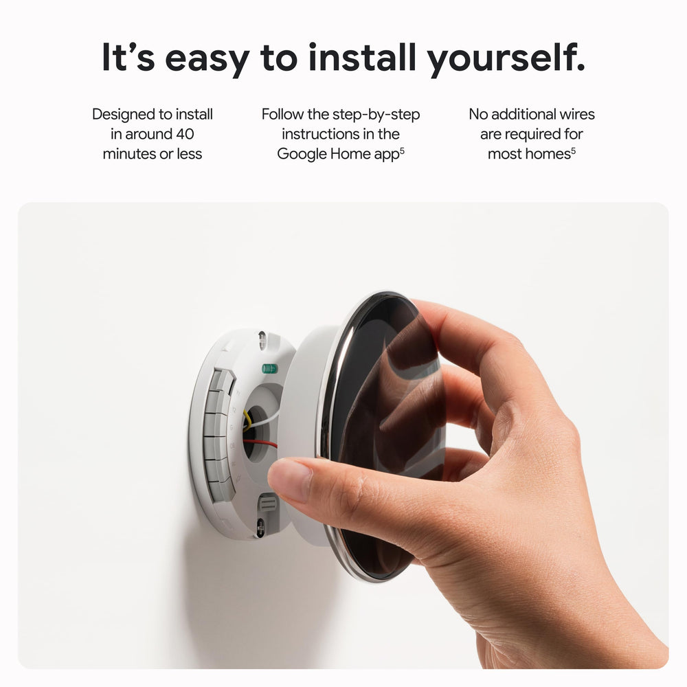 Google Nest thermostat held in hand to show scale and easy installation advantage