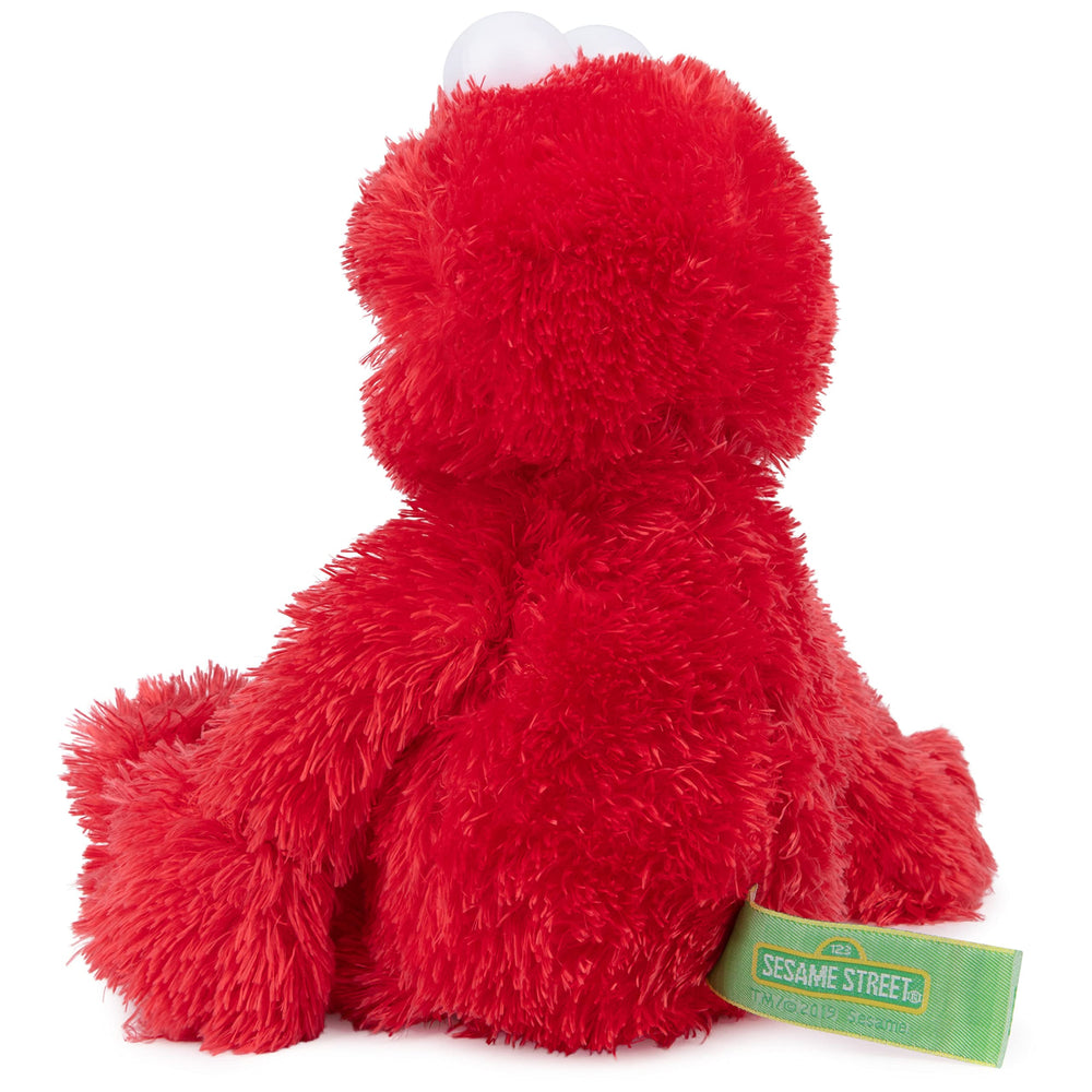 GUND Elmo abrazado por niño que muestra confort y compañía