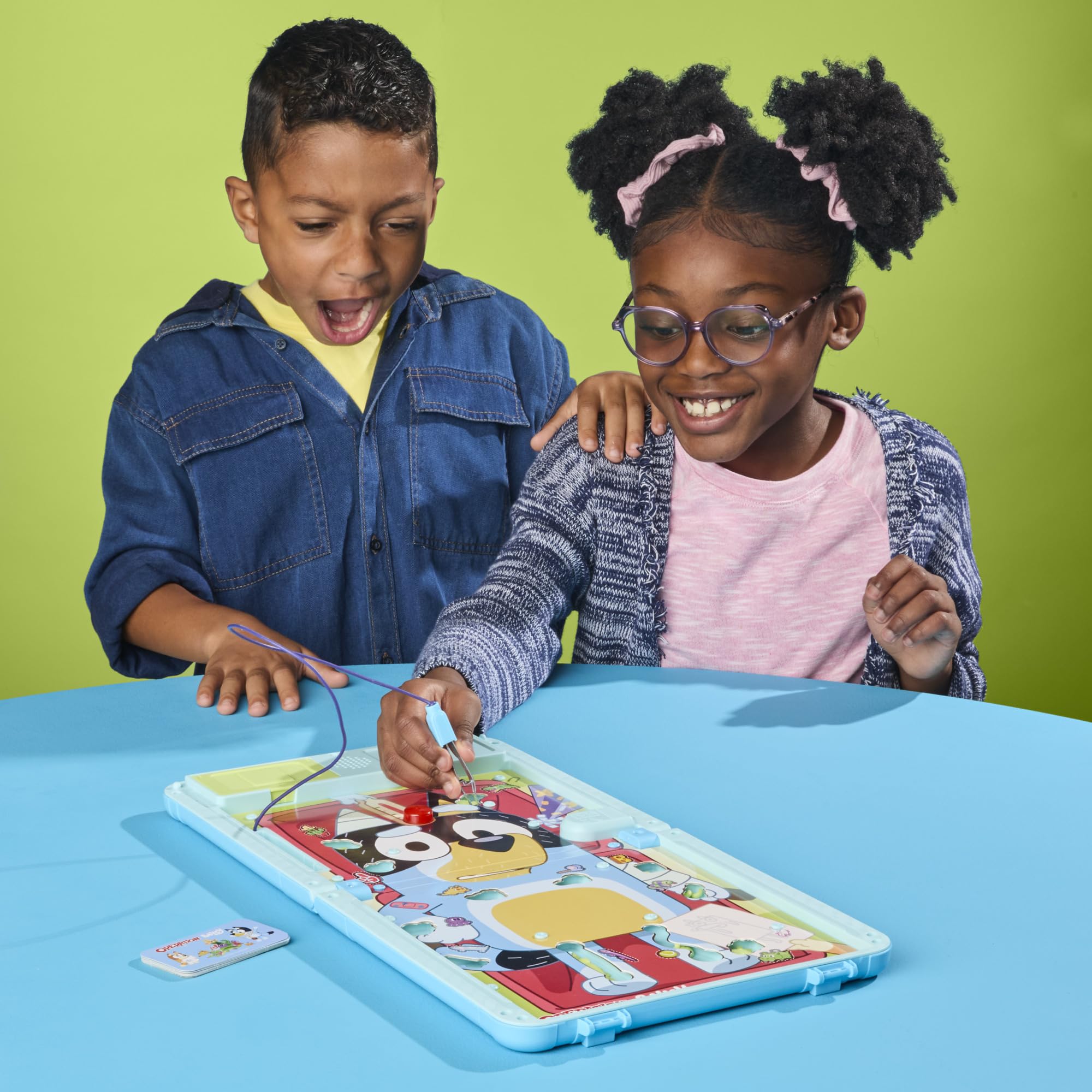 Hasbro manos sosteniendo cartas X-ray que indican la pieza a extraer