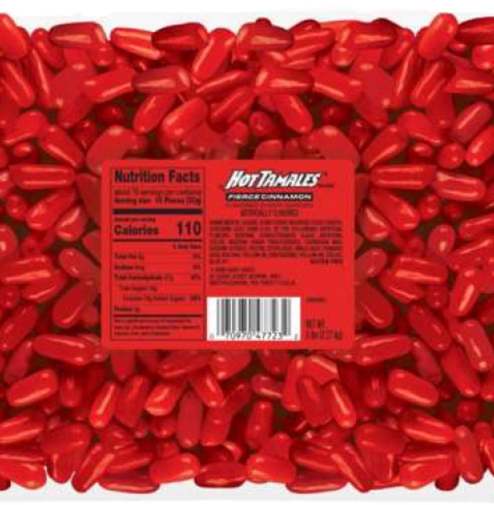 Hot TAMALES comparación de tamaño con mano y regla para referencia de escala