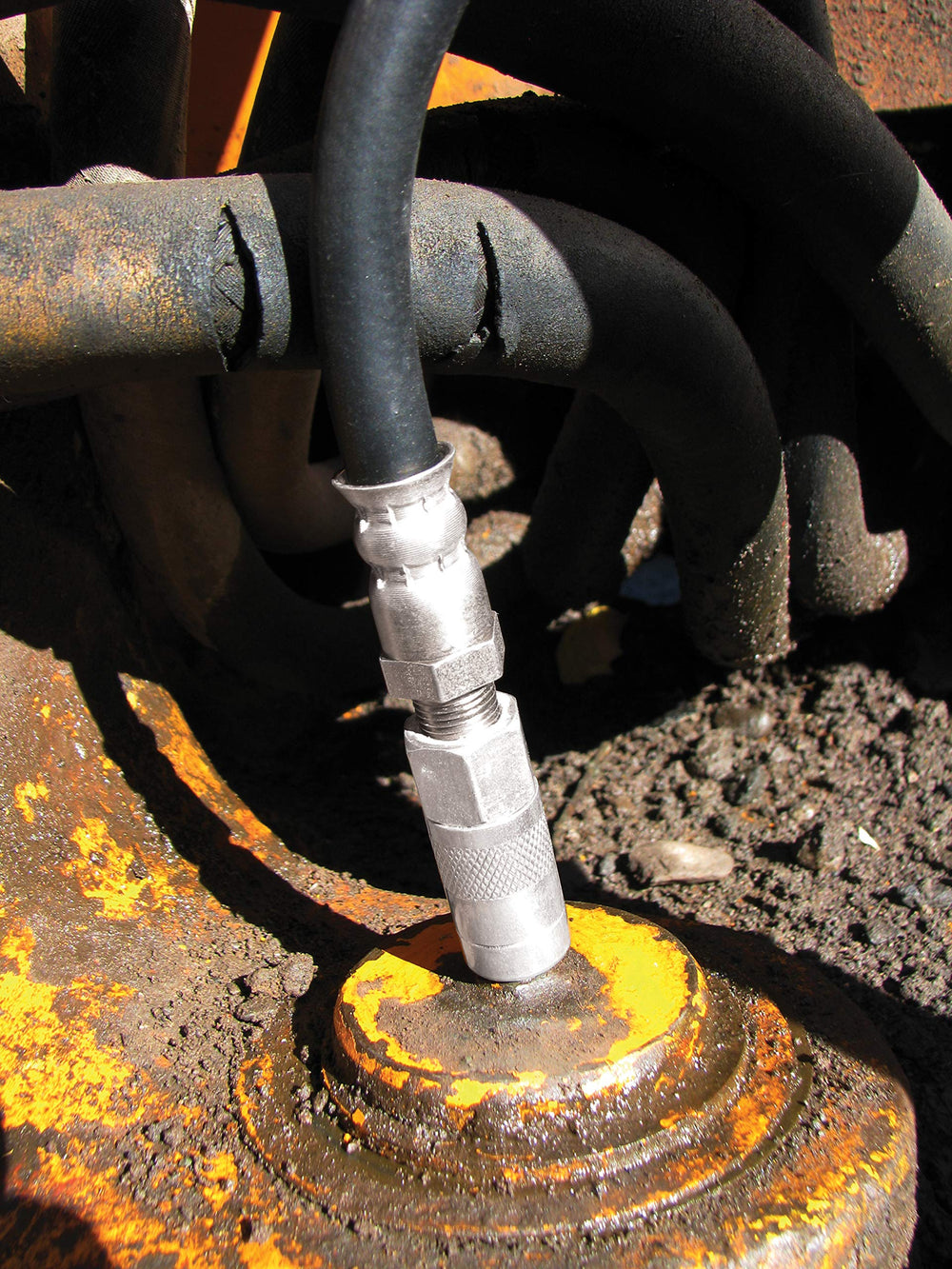 Innovative Products of America flushed residue exiting a bushing illustrating restored lubricant channels