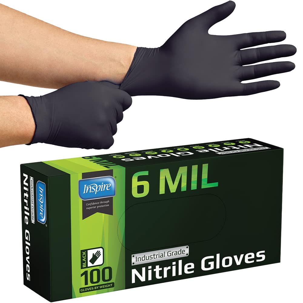 Inspire gloves on mechanic at workbench, protecting hands during repairs benefit