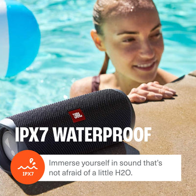 JBL Flip 5 held in hand to show compact size for easy portability and travel convenience