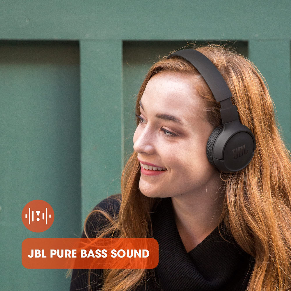 JBL Tune 510BT in hand for scale showing lightweight, travel-friendly size