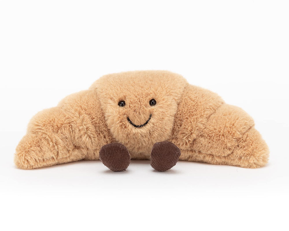 Jellycat croissant colocado en cuna para decorar habitación infantil