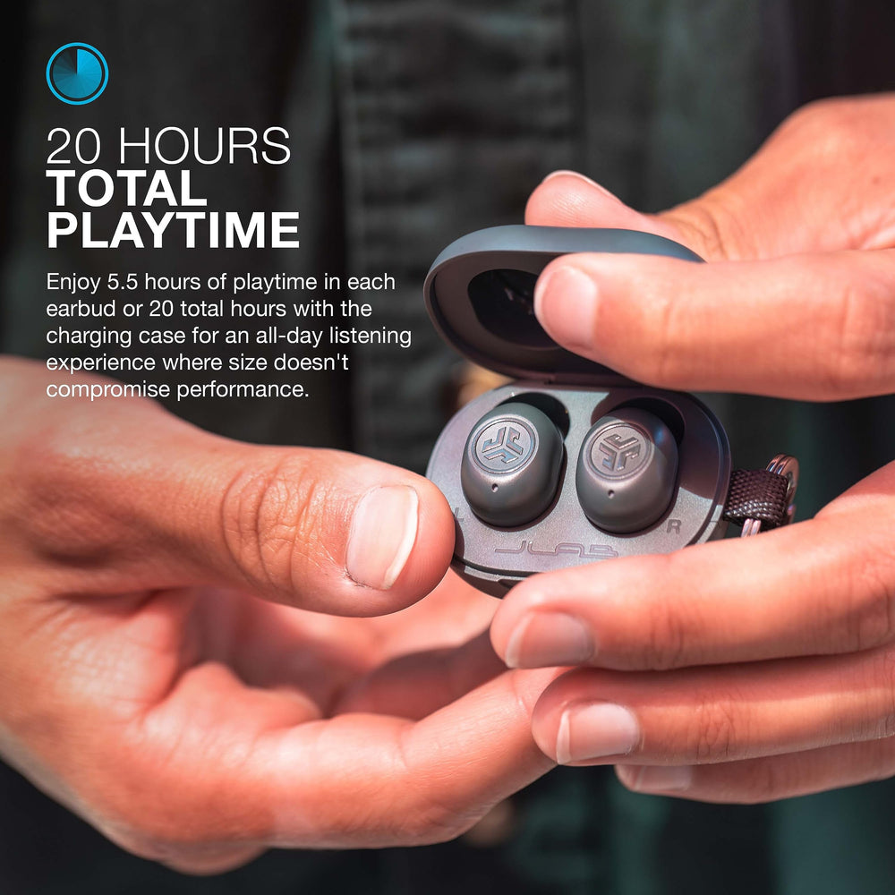 Person wearing JLab JBuds Mini during commute - secure fit and ambient awareness