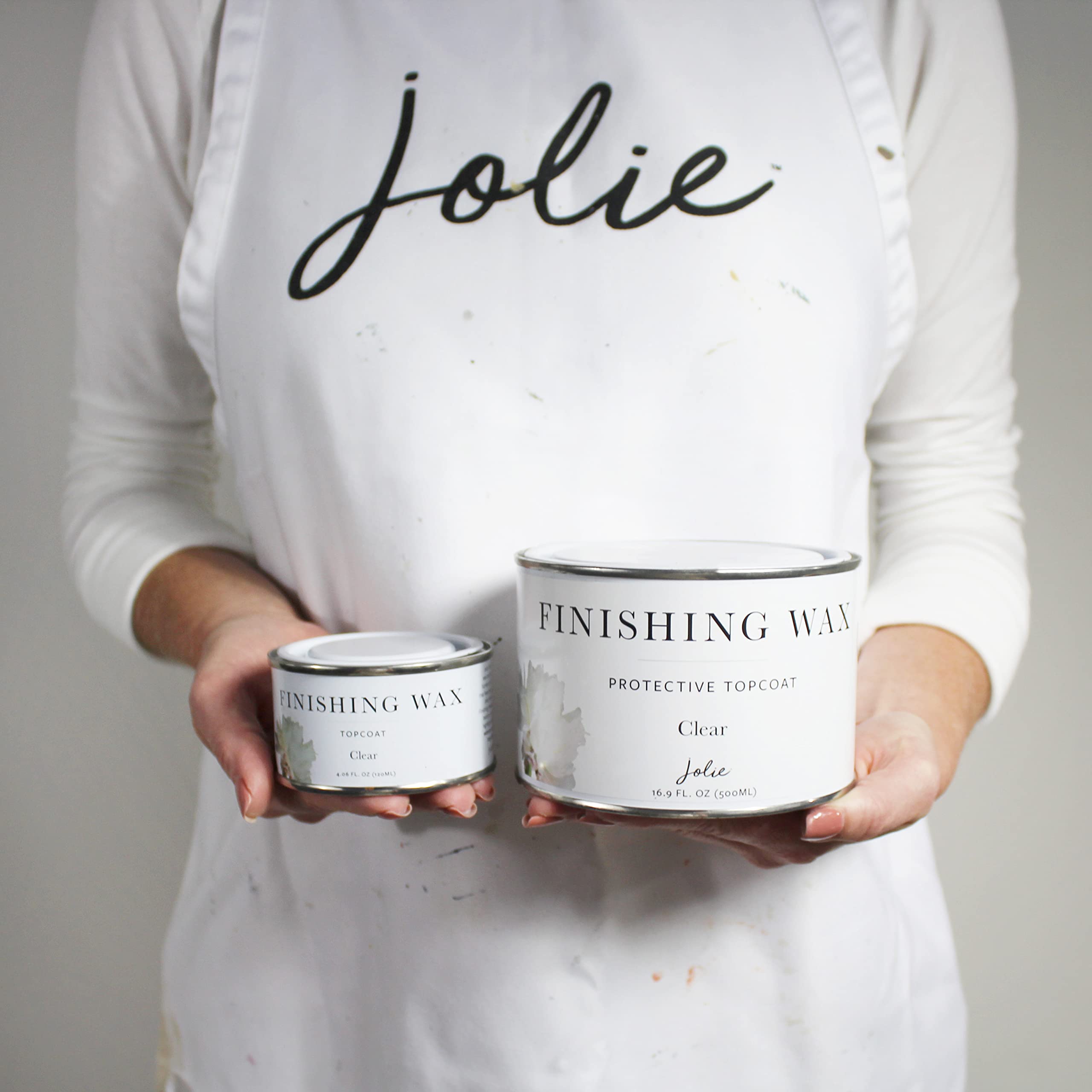 Jolie applying wax with brush to cabinet demonstrating even coverage