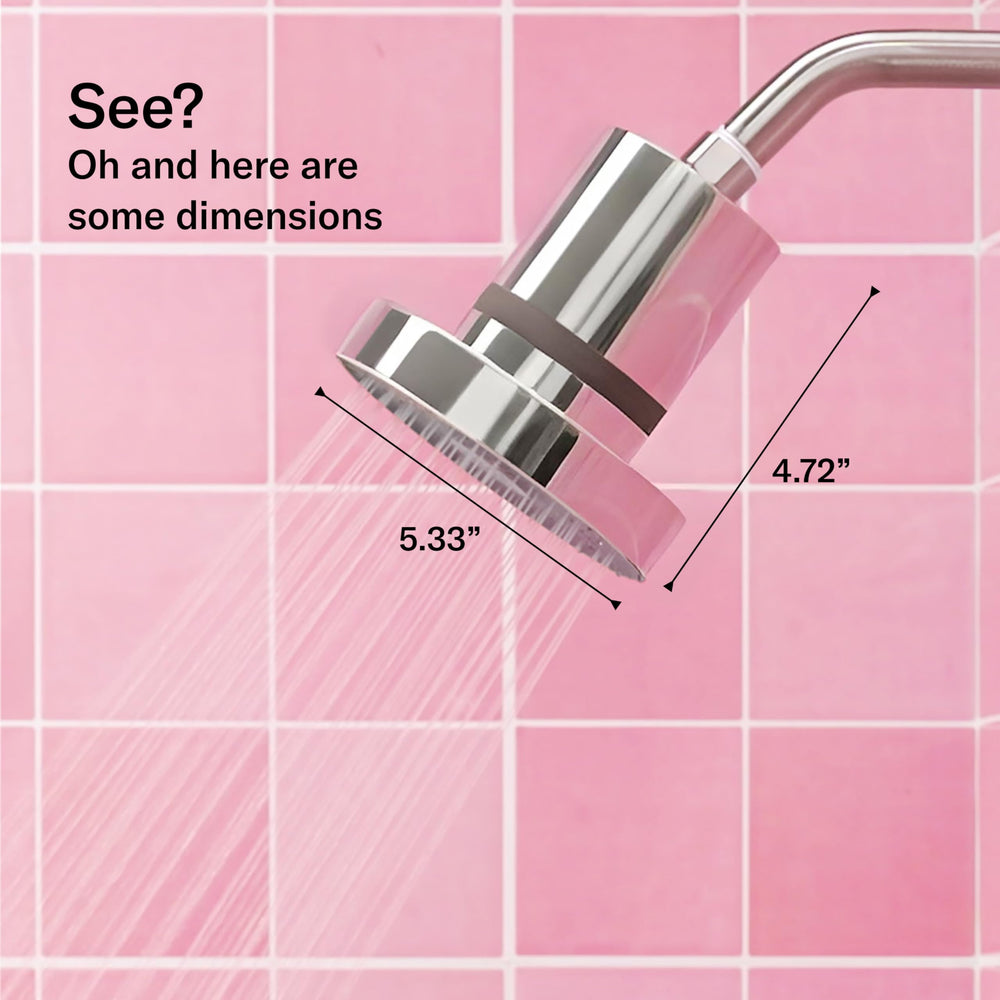 Jolie Skin Company showerhead next to a hand to show scale and easy handling