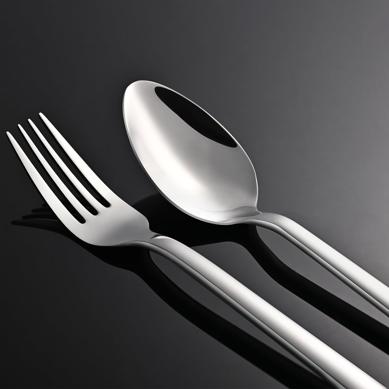 KINGSTONE flatware next to a hand showing true-to-size scale and ergonomic feel