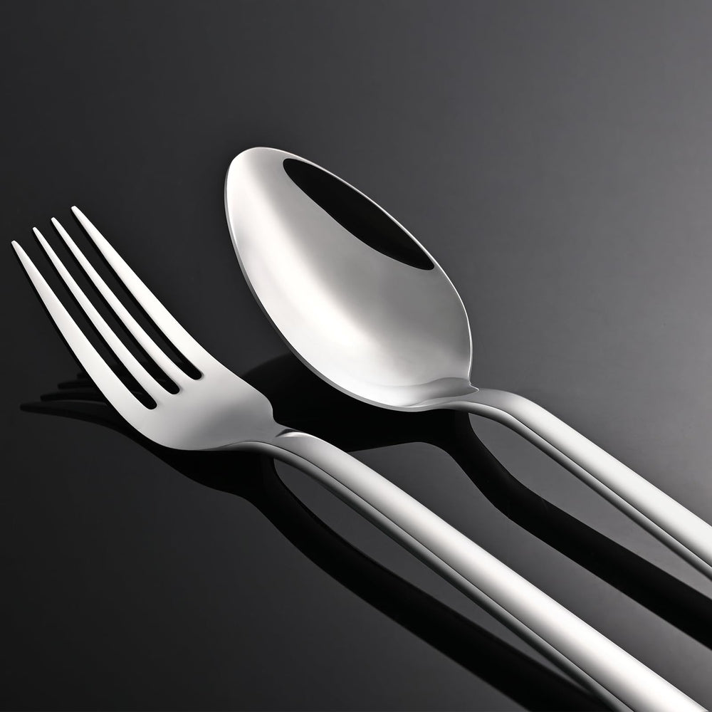 KINGSTONE flatware next to a hand showing true-to-size scale and ergonomic feel