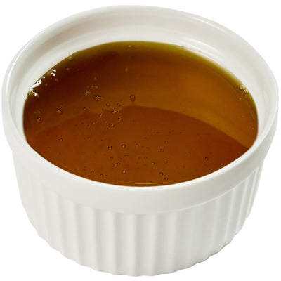 Kraft honey 9 g packet beside a coin for scale, brand showing portion size