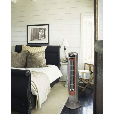 Lasko tower fan next to chair showing 42-inch height for room reach