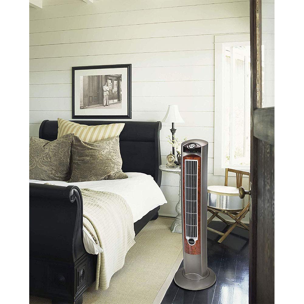 Lasko tower fan next to chair showing 42-inch height for room reach