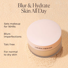 Brush picking up Laura Mercier powder, illustrating easy application and control