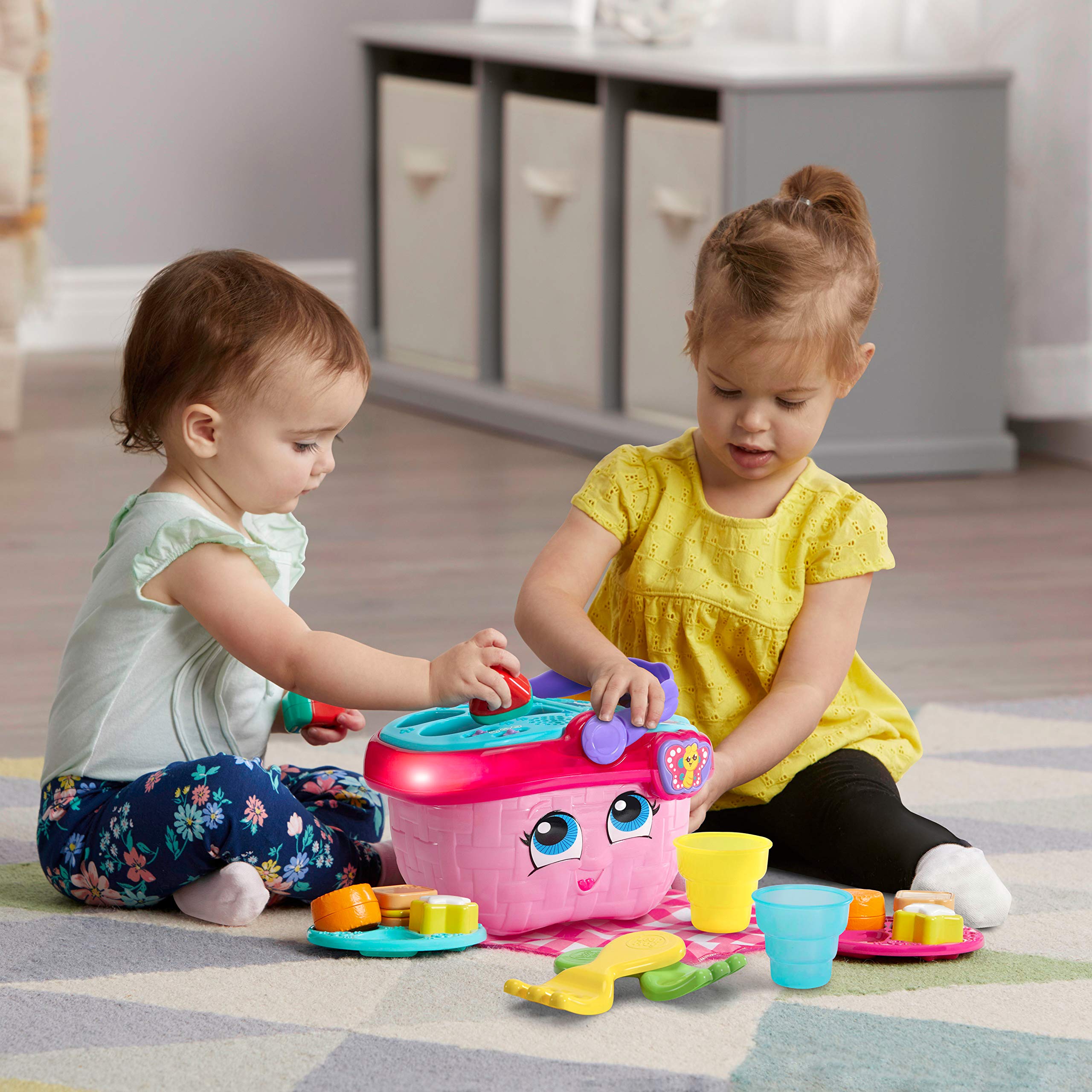 LeapFrog picnic set used by toddler, demonstrating sharing and pretend-play
