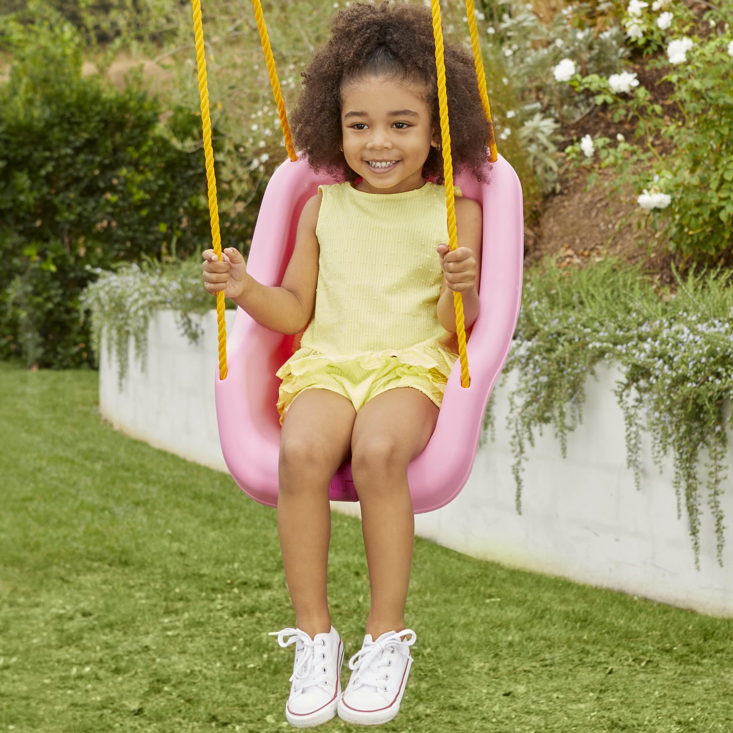 Little Tikes columpio en uso en jardín para juego exterior seguro