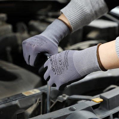 LOCCEF gloves in use gripping hand tools to demonstrate dexterity and secure hold
