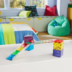 MAGNA-TILES rails in use extending a racetrack for longer runs and speed