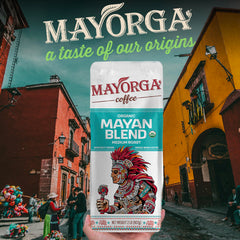 Mayorga 2lb bag next to a coffee grinder to show scale and quantity benefit