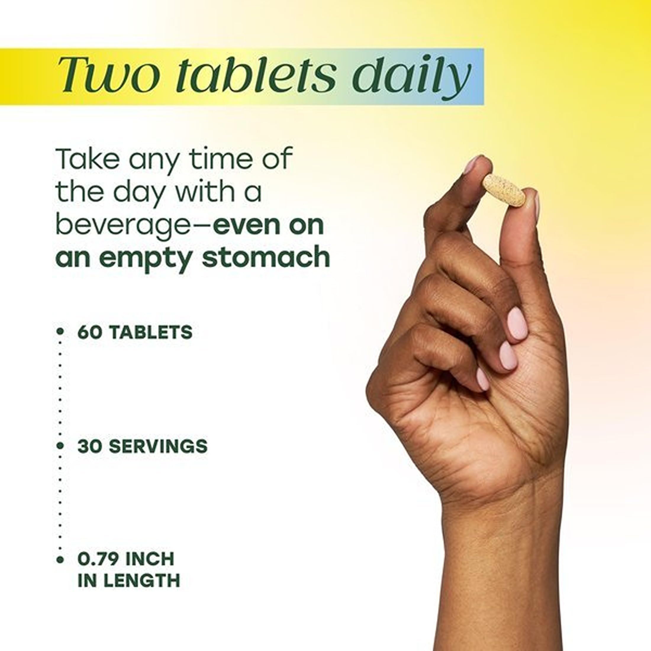 Hand holding MegaFood tablets to show count and tablet shape