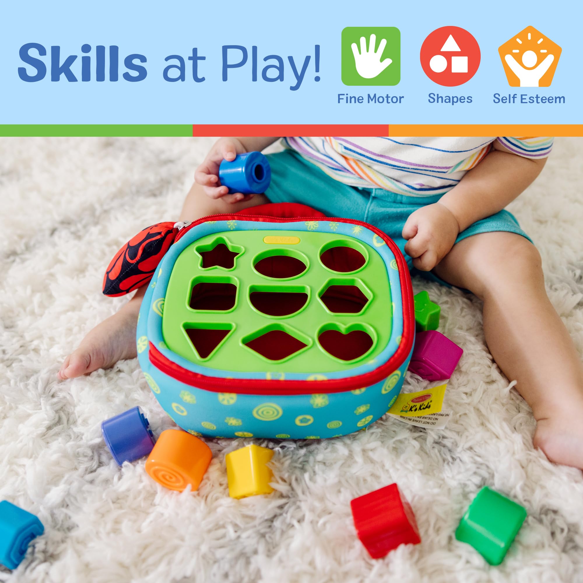 Melissa & Doug toddler playing with the sorter on lap promoting independent fine motor practice