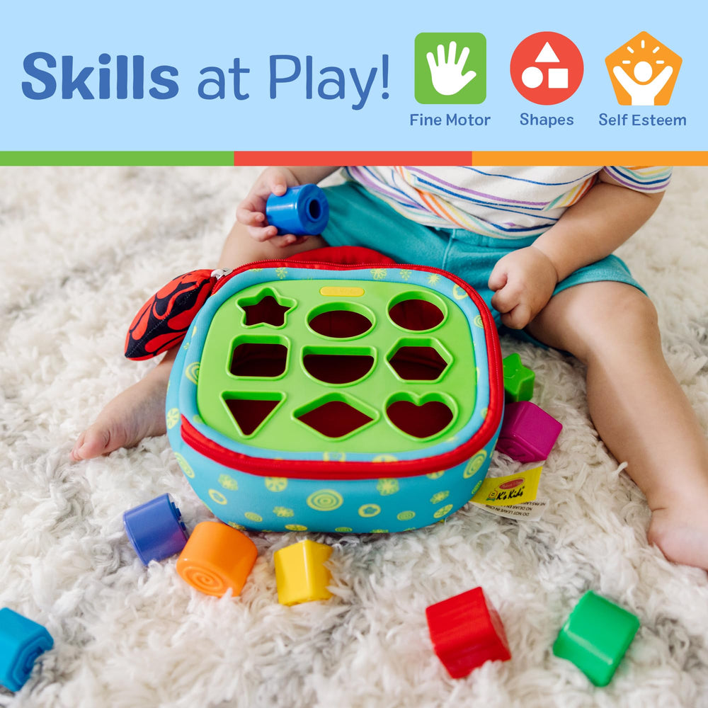 Melissa & Doug toddler playing with the sorter on lap promoting independent fine motor practice