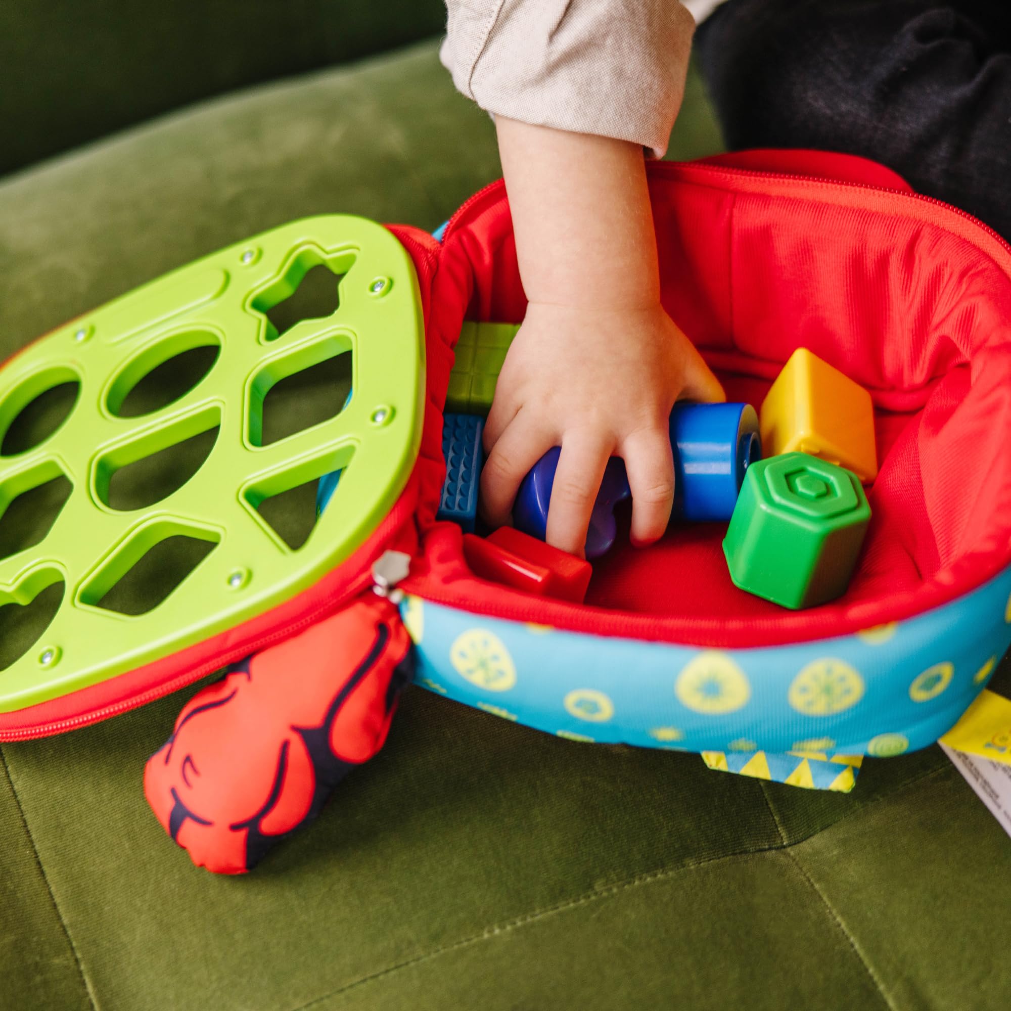 Melissa & Doug sorter next to toy car for scale illustrating compact, travel-ready size