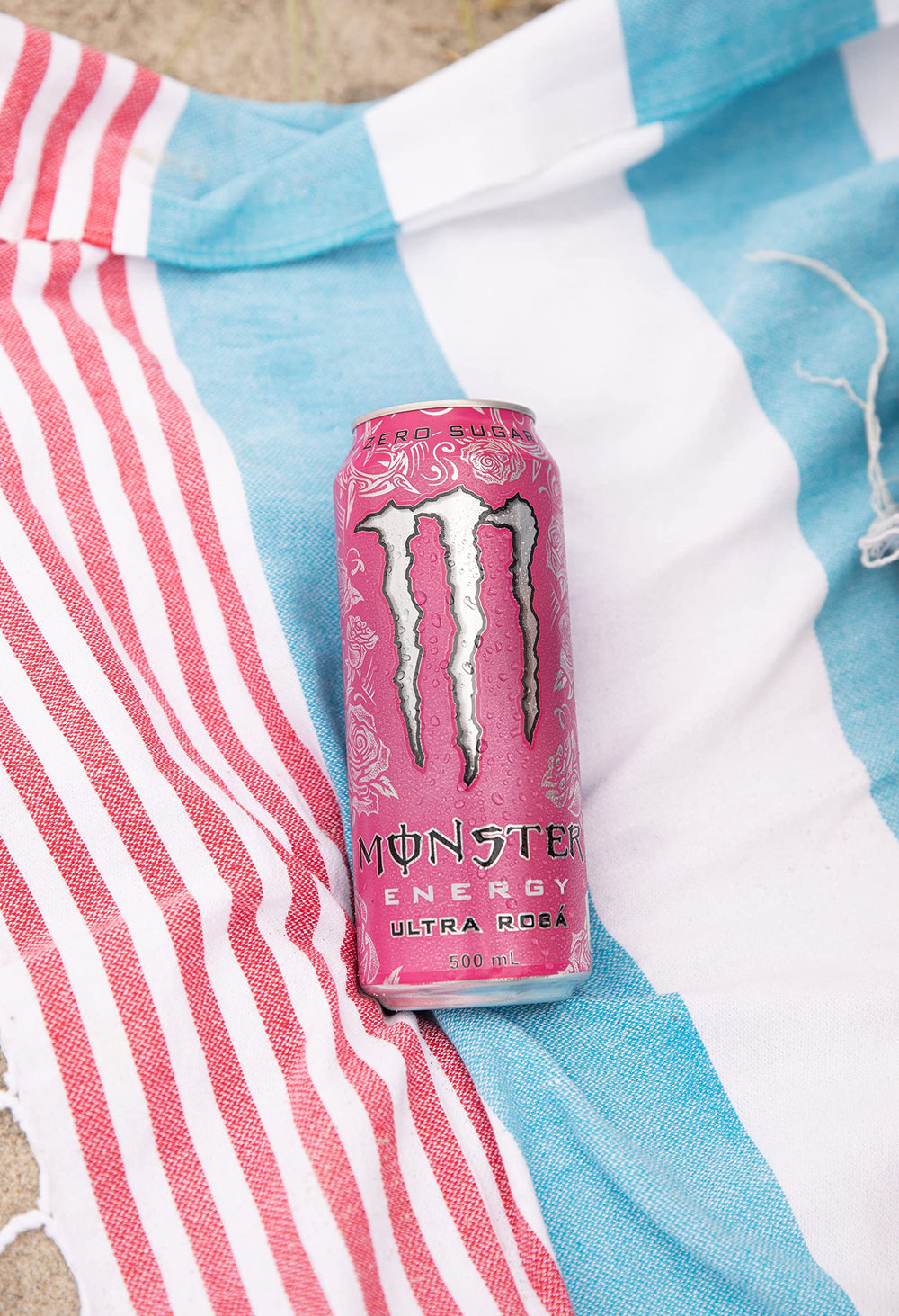 Opened Monster Ultra Rosa can in a casual setting suggesting refreshing, sugar-free boost