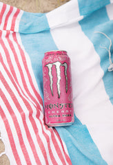Opened Monster Ultra Rosa can in a casual setting suggesting refreshing, sugar-free boost
