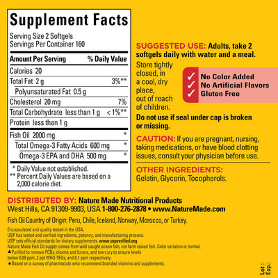 Hand holding a Nature Made fish oil softgel demonstrating small size and daily use convenience