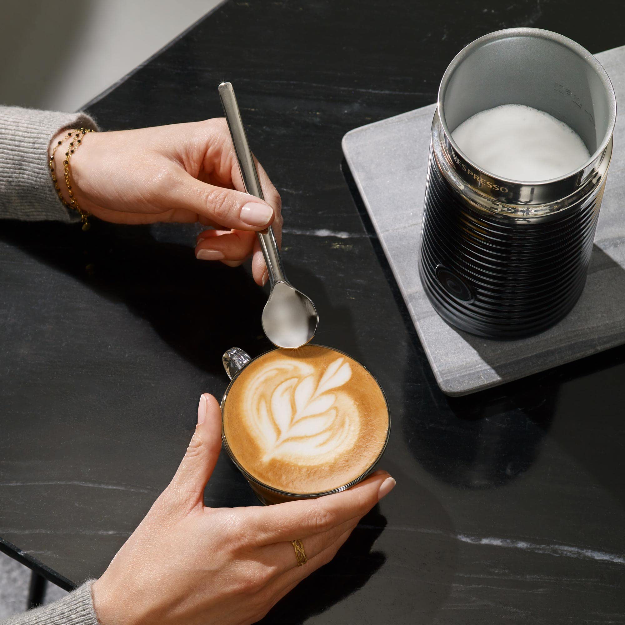 Nespresso Aeroccino 3 on kitchen counter near coffee setup benefit: stylish complement to espresso machines