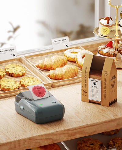 NIIMBOT B1 with three included rolls laid out, ready-to-use for immediate labeling