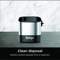 Ninja knock box in use with portafilter knocking out puck for fast cleanup benefit