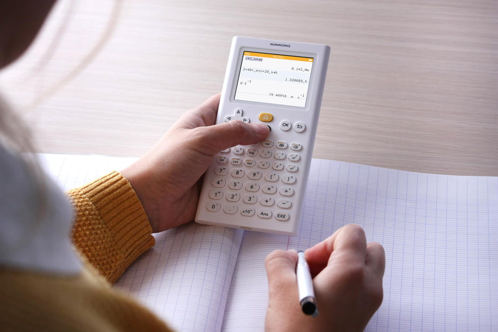 NumWorks on study desk with books showing classroom-ready utility