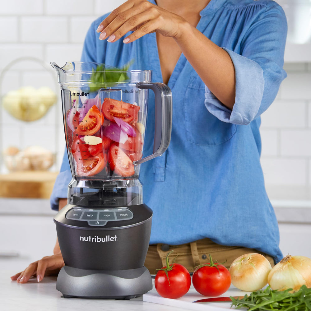 NutriBullet next to whole fruits for size comparison demonstrating generous 64oz capacity