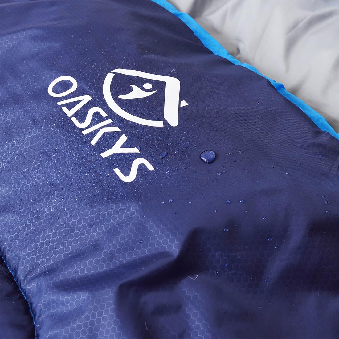 oaskys sleeping bag beside backpack showing size and packing convenience benefit