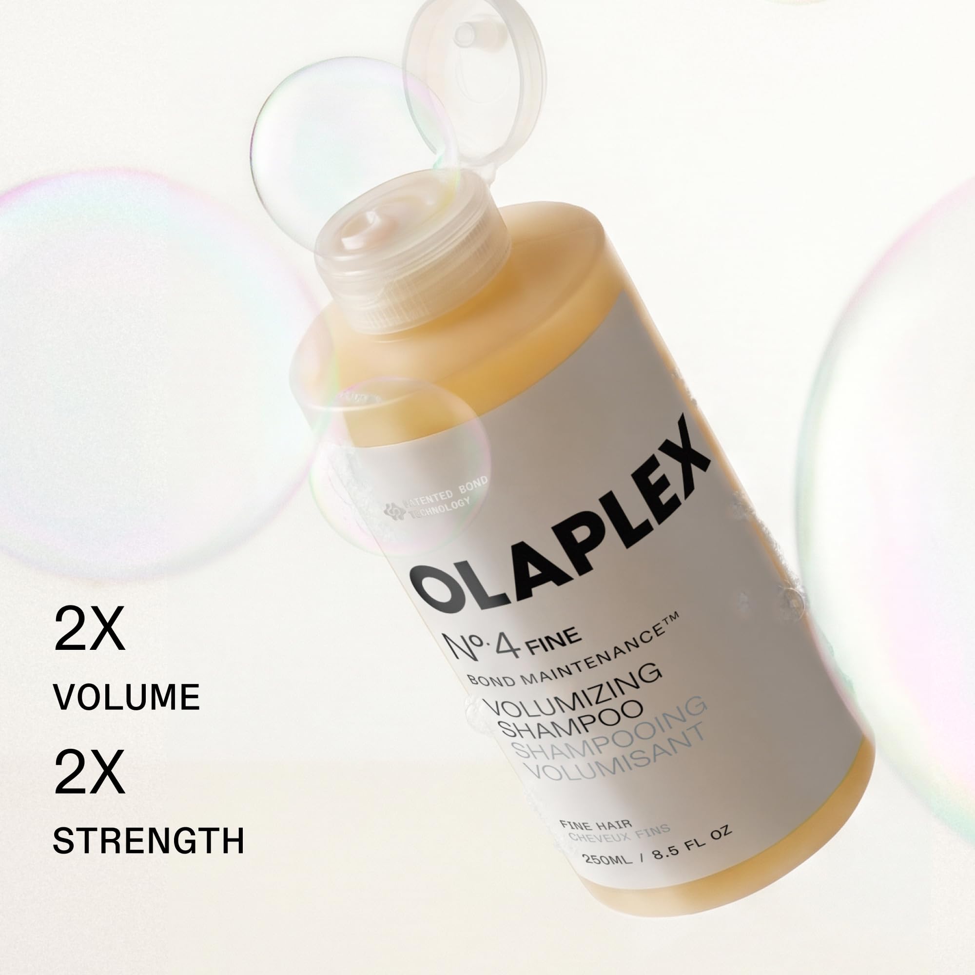 Olaplex No.4FINE pump dispensing shampoo into hand to show easy application