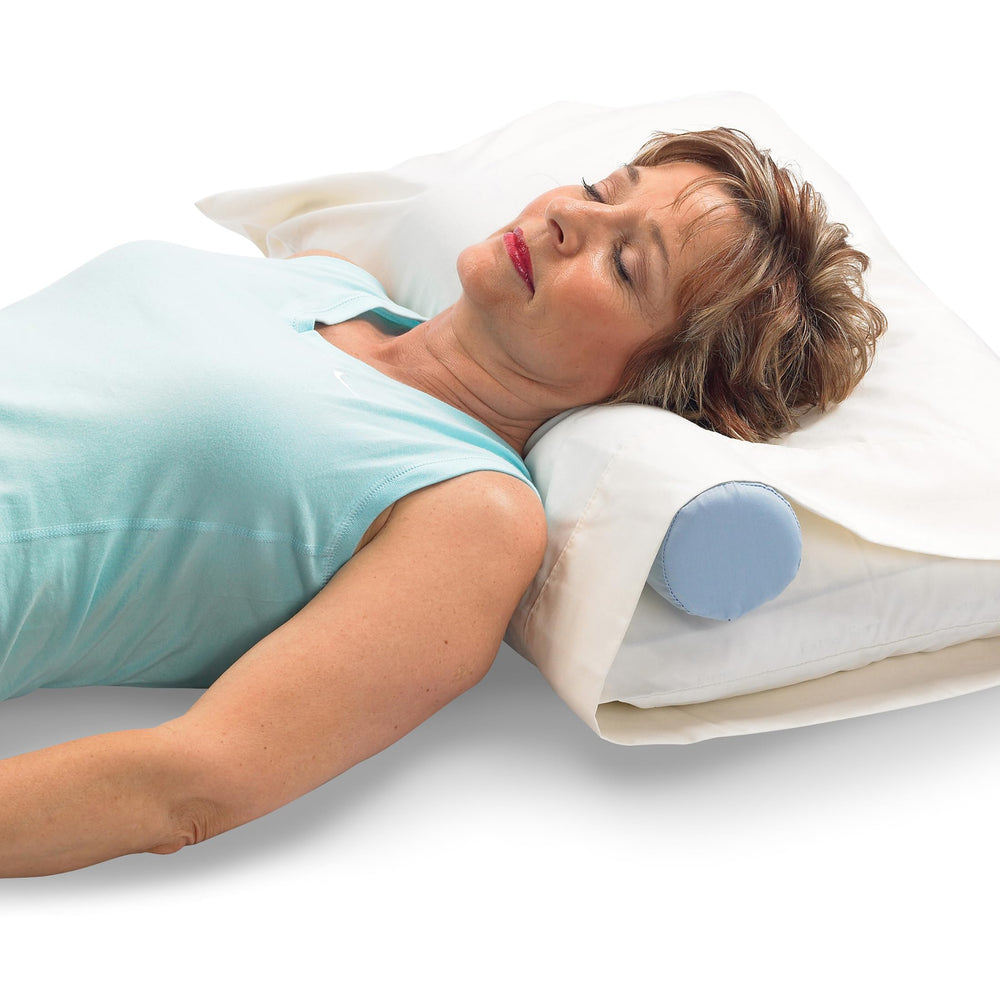 OPTP cervical roll lifestyle bedroom setting showing comfortable nightly use