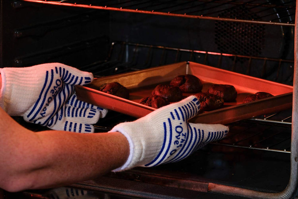 Ove Glove pulling hot oven pan demonstrating safe kitchen use and control