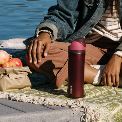 Owala FreeSip on picnic blanket showing outdoor use and cold-beverage convenience