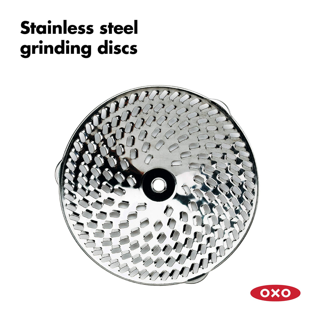 OXO food mill over pot in use straining sauce for seed-free texture