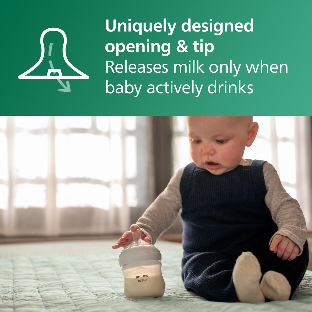 Philips Avent bottle held in adult hand showing ergonomic shape and easy grip benefit
