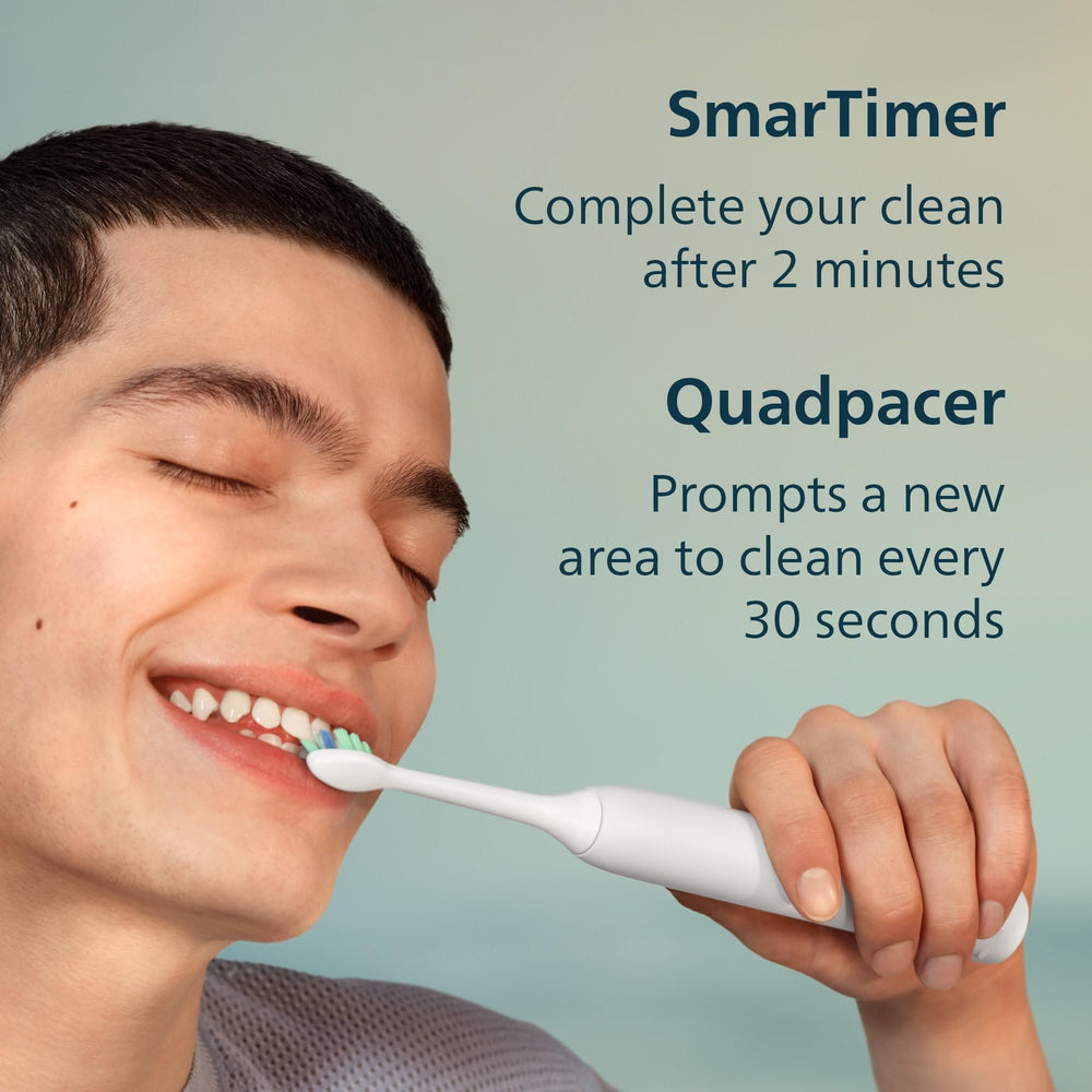 Philips Sonicare toothbrush in use in bathroom showing consistent timed brushing benefit
