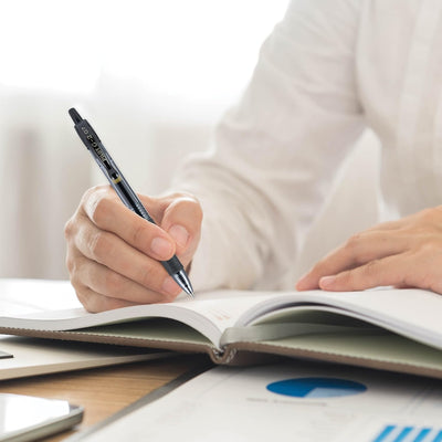 PILOT G2 pen writing on notebook at desk showing smooth gel flow for productivity