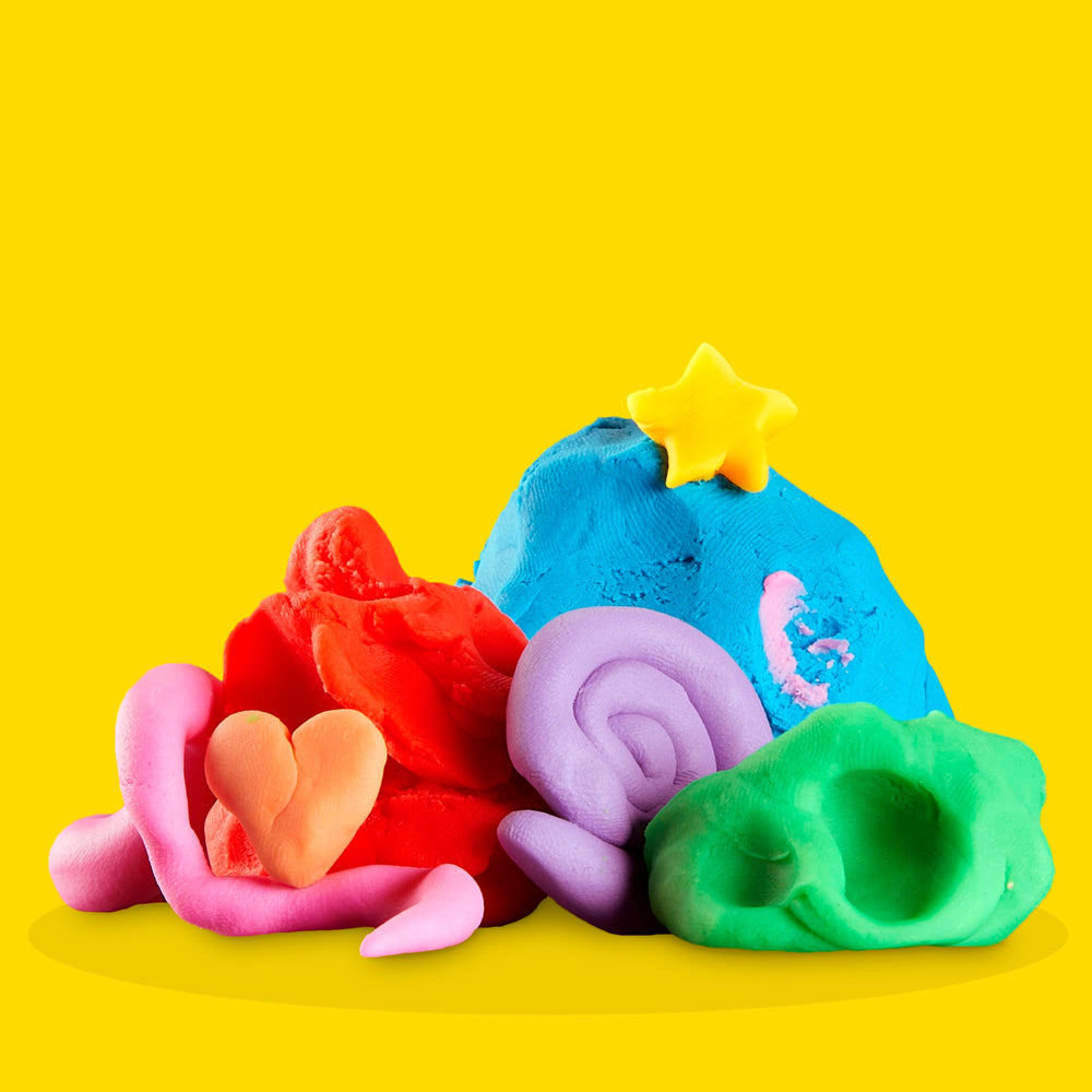 Child using Play‑Doh hands sculpting shapes showing tactile creativity