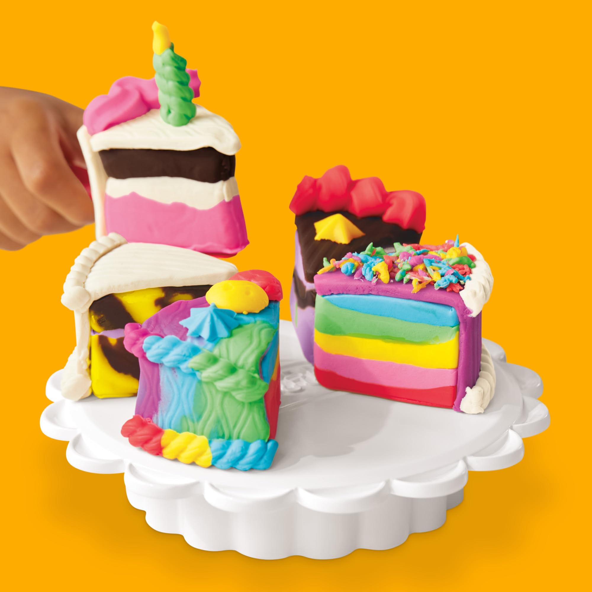 Child using Play‑Doh Super Slice Cake Playset in a playroom, demonstrating imaginative role play